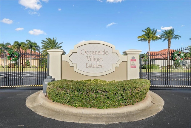 community / neighborhood sign featuring a gate