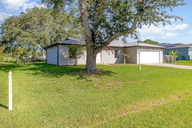 ranch-style house featuring a front yard and a garage