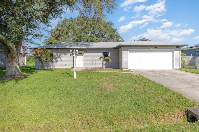 single story home featuring a garage and a front yard