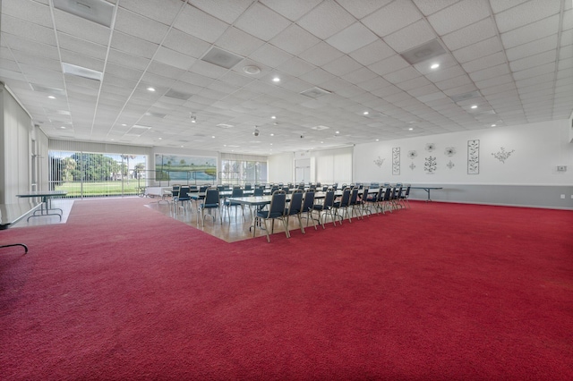 workout area featuring carpet and a paneled ceiling