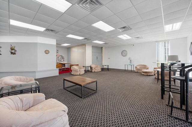 carpeted living room with a drop ceiling