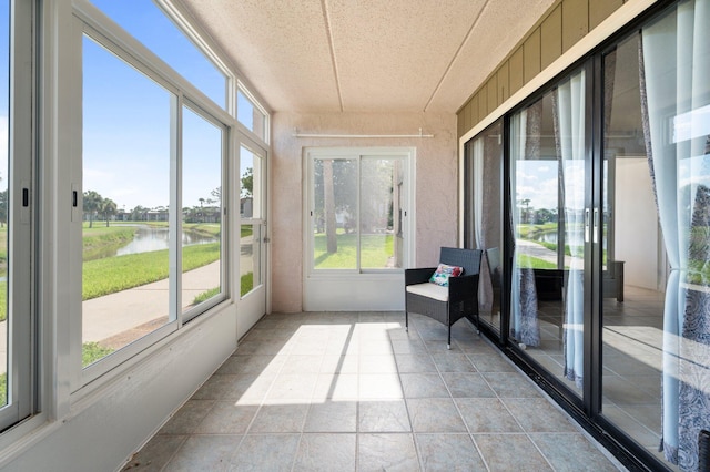 sunroom / solarium with a water view