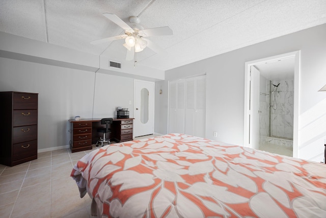 bedroom featuring a textured ceiling, ensuite bathroom, ceiling fan, and light tile patterned floors