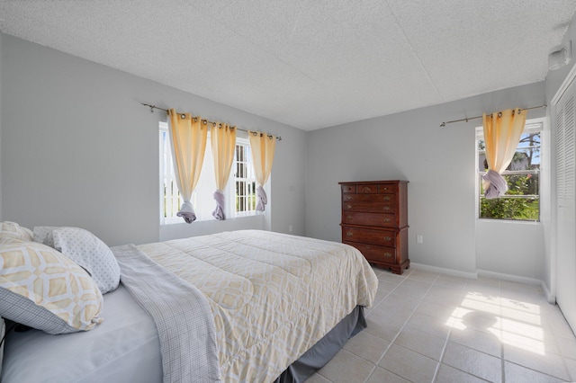 tiled bedroom with a textured ceiling