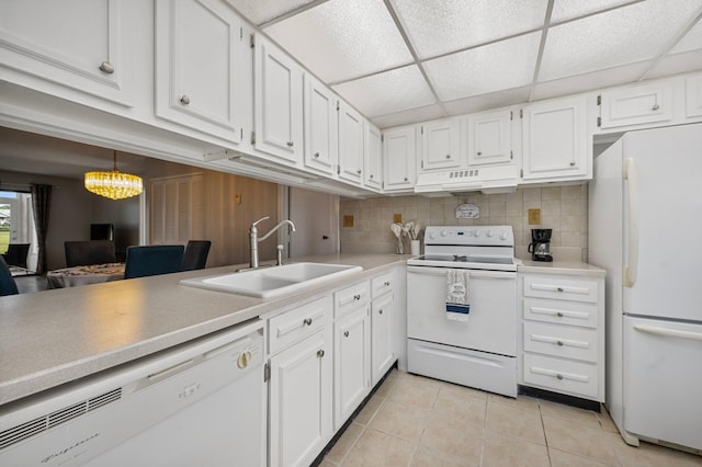 kitchen featuring white cabinetry, sink, a drop ceiling, white appliances, and custom range hood