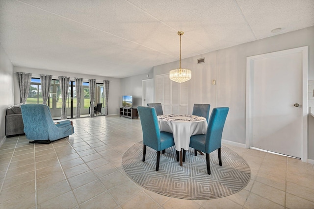 tiled dining space with an inviting chandelier