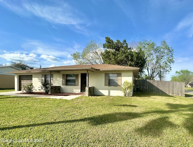 2442 Dianne Dr, Cocoa, FL 32926 - ranch-style house with stucco siding, a garage, and driveway