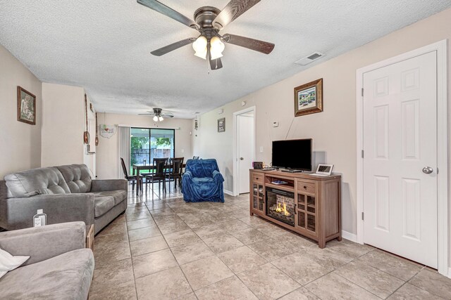 2442 Dianne Dr, Cocoa, FL 32926 - living room with a ceiling fan and a textured ceiling
