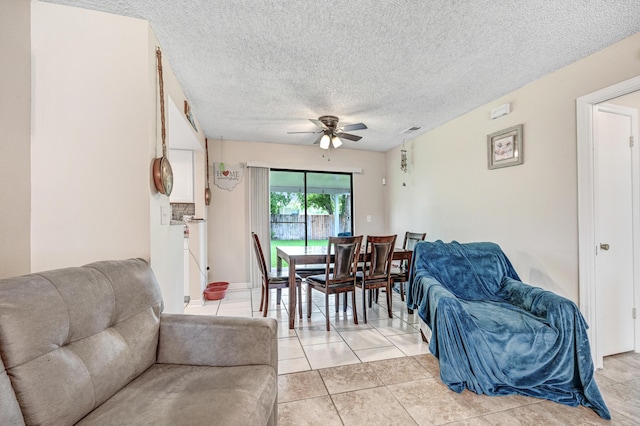 2442 Dianne Dr, Cocoa, FL 32926 - living area with a ceiling fan, light tile patterned floors, and a textured ceiling