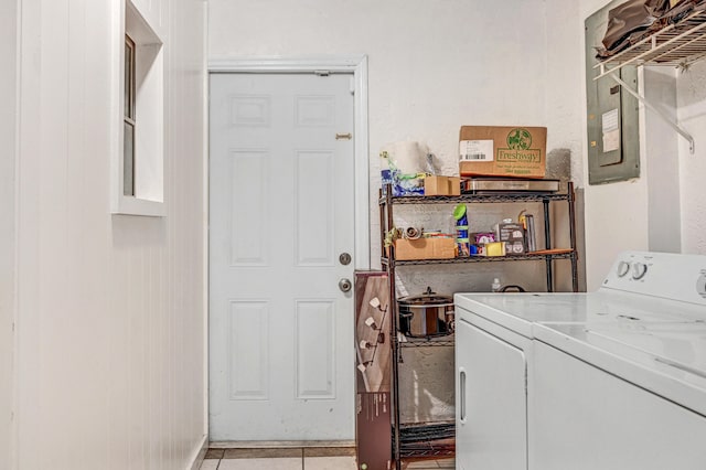 laundry room with washer and clothes dryer and light tile patterned floors