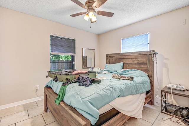 2442 Dianne Dr, Cocoa, FL 32926 - bedroom with tile patterned floors, baseboards, ceiling fan, and a textured ceiling