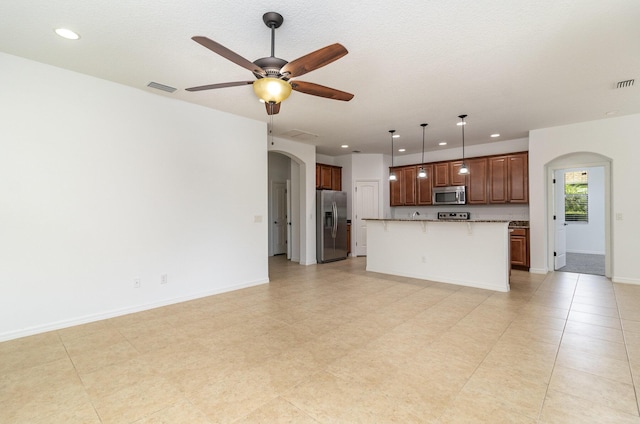 unfurnished living room featuring ceiling fan