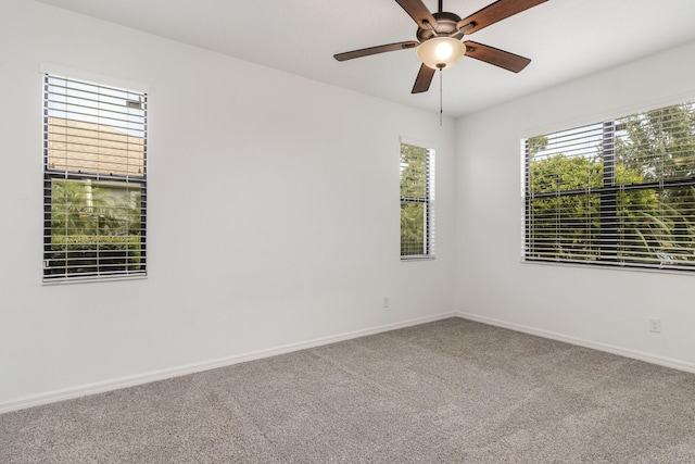 spare room featuring carpet flooring and ceiling fan