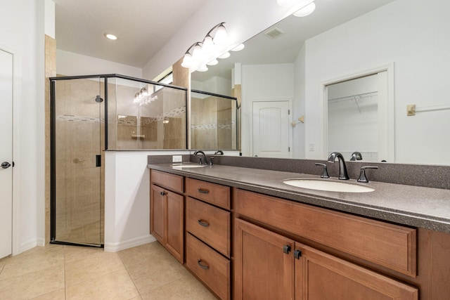 bathroom with vanity, an enclosed shower, and tile patterned floors