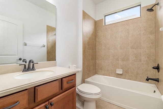 full bathroom featuring tiled shower / bath, vanity, and toilet