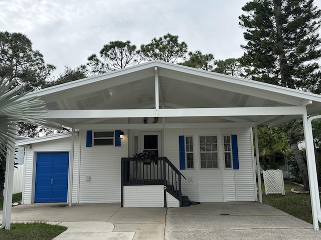 view of front of home with a carport and a garage