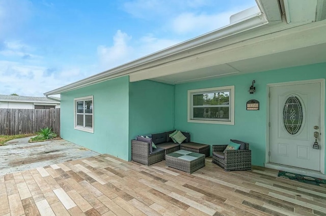 property entrance featuring an outdoor hangout area and a wooden deck