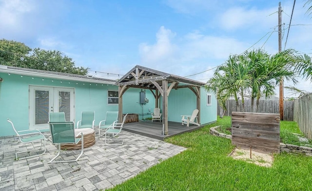 rear view of house with a gazebo and a wooden deck