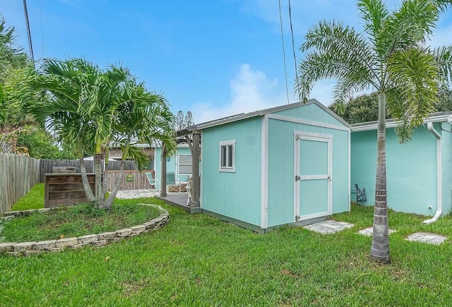 view of outbuilding with a lawn