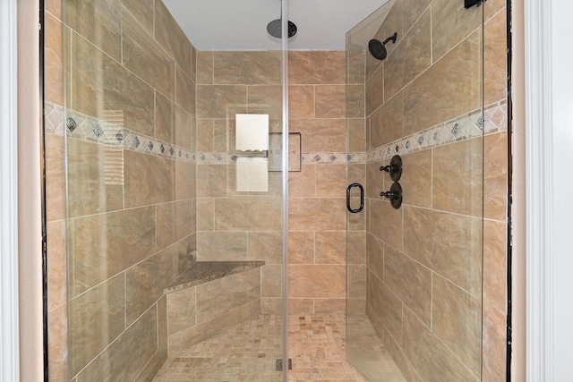 bathroom with a shower with door