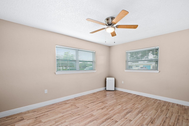 unfurnished room with ceiling fan, light hardwood / wood-style floors, and a textured ceiling