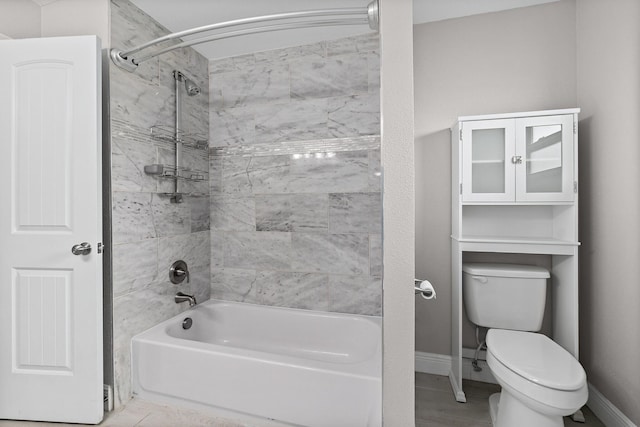 bathroom featuring toilet and tiled shower / bath