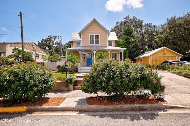 view of front of property featuring covered porch and an outbuilding