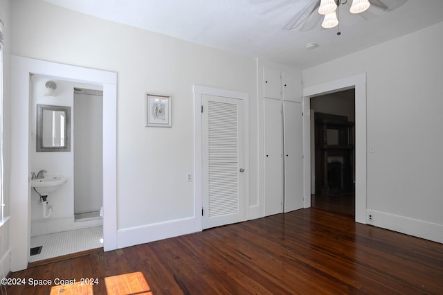 unfurnished bedroom with dark hardwood / wood-style floors, ensuite bath, and ceiling fan