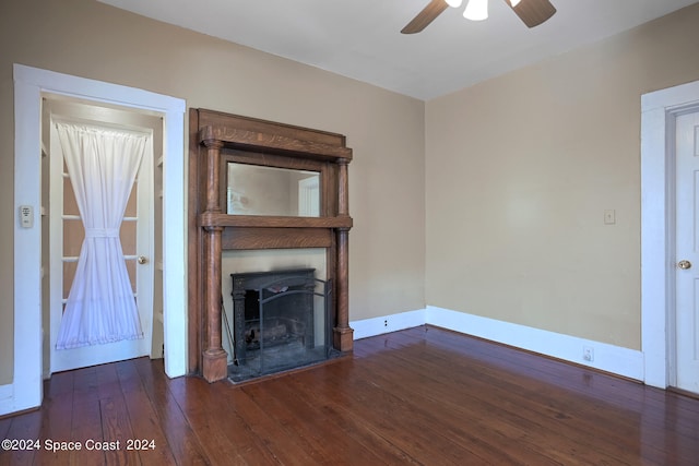 unfurnished living room with ceiling fan and dark hardwood / wood-style flooring