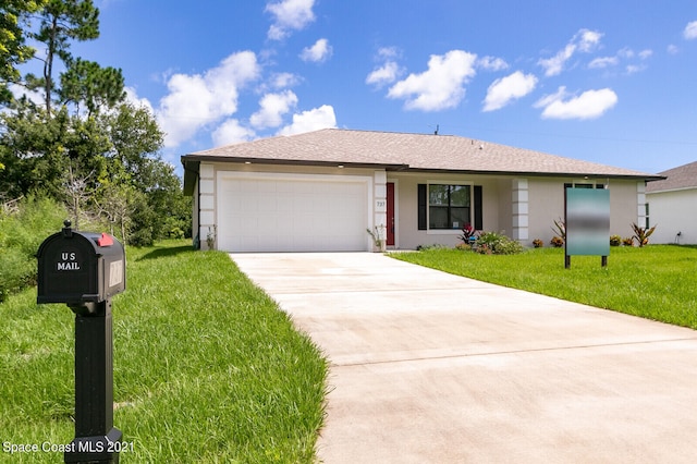 ranch-style home with a garage and a front yard