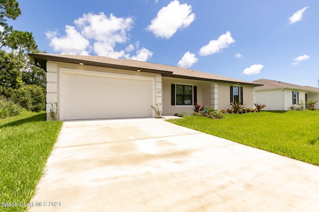 ranch-style home with a garage and a front lawn