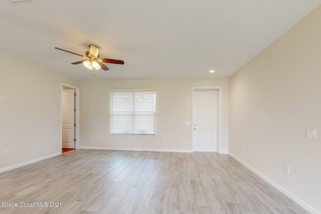 empty room featuring light wood-type flooring and ceiling fan