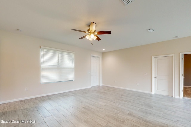 spare room featuring light hardwood / wood-style flooring and ceiling fan