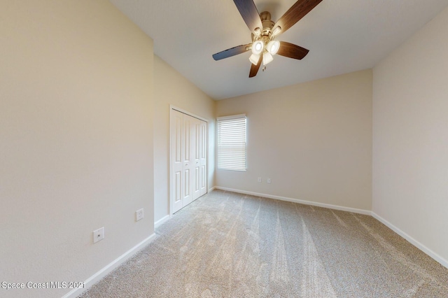 1071 Grapefruit Rd SE, Palm Bay, FL 32909 - unfurnished bedroom with light colored carpet, a closet, and ceiling fan