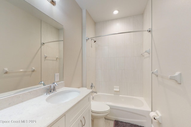 full bathroom featuring vanity, tiled shower / bath combo, toilet, and tile patterned flooring