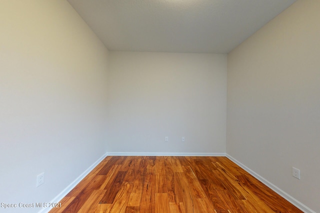 unfurnished room with wood-type flooring