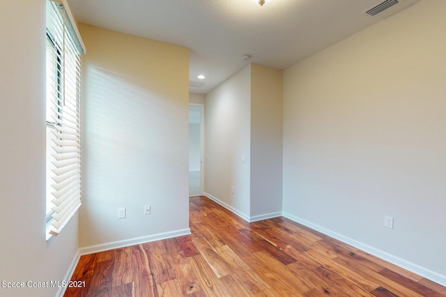 1071 Grapefruit Rd SE, Palm Bay, FL 32909 - unfurnished room with wood finished floors and recessed lighting