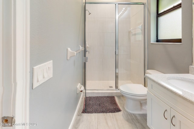 bathroom with vanity, toilet, and wood-type flooring