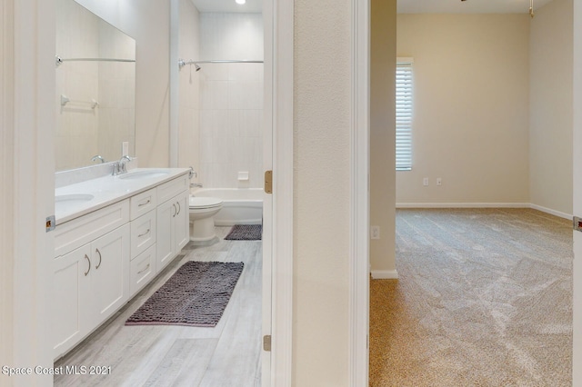 full bathroom with tiled shower / bath combo, toilet, and dual bowl vanity