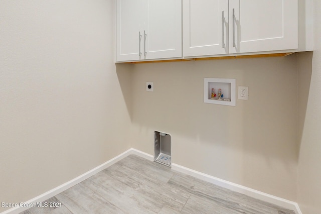 laundry room with electric dryer hookup, washer hookup, light wood-type flooring, and cabinets