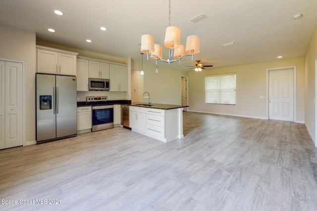 1071 Grapefruit Rd SE, Palm Bay, FL 32909 - kitchen with stainless steel appliances, dark countertops, a peninsula, ceiling fan, and recessed lighting