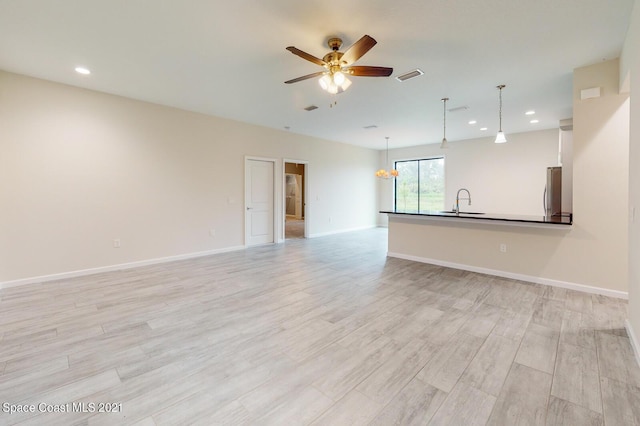 1071 Grapefruit Rd SE, Palm Bay, FL 32909 - unfurnished living room with ceiling fan, light wood finished floors, and recessed lighting