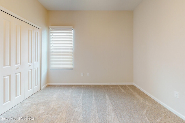 unfurnished bedroom with a closet and carpet