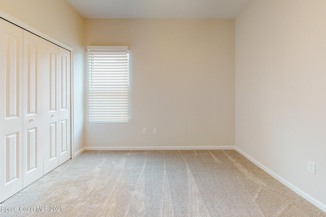1071 Grapefruit Rd SE, Palm Bay, FL 32909 - unfurnished bedroom featuring carpet flooring and a closet