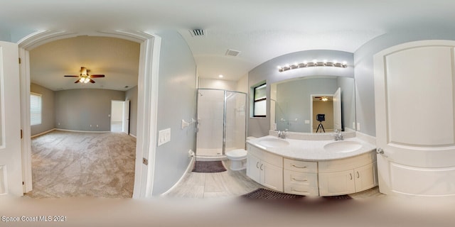 bathroom with vanity, an enclosed shower, ceiling fan, and toilet