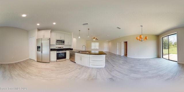 kitchen featuring stainless steel appliances, an inviting chandelier, sink, hanging light fixtures, and white cabinetry