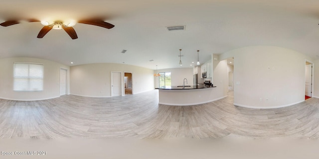 unfurnished living room featuring ceiling fan