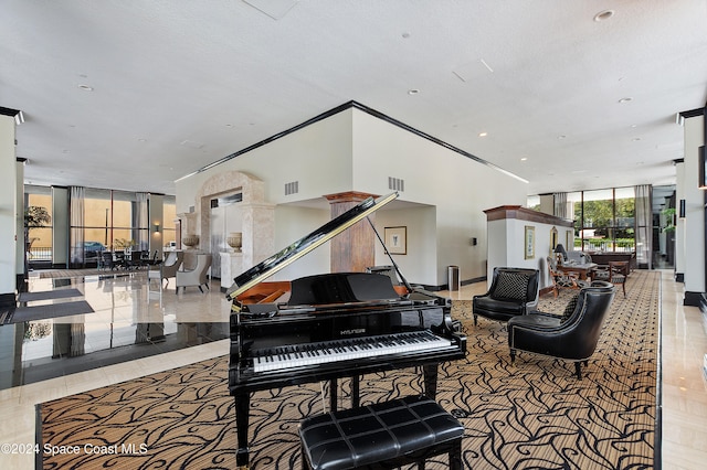 misc room with light tile patterned floors, a textured ceiling, and floor to ceiling windows