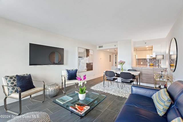 living room featuring dark hardwood / wood-style flooring and sink