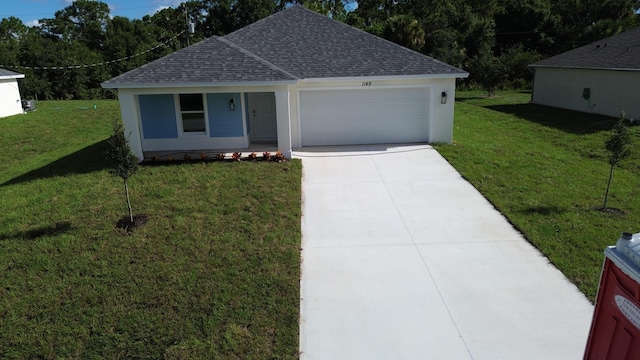 view of front of house with a front yard and a garage